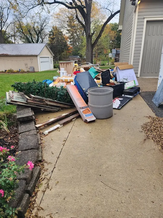 Dumpster being loaded with debris for Residential Dumpster Rental in Rossford